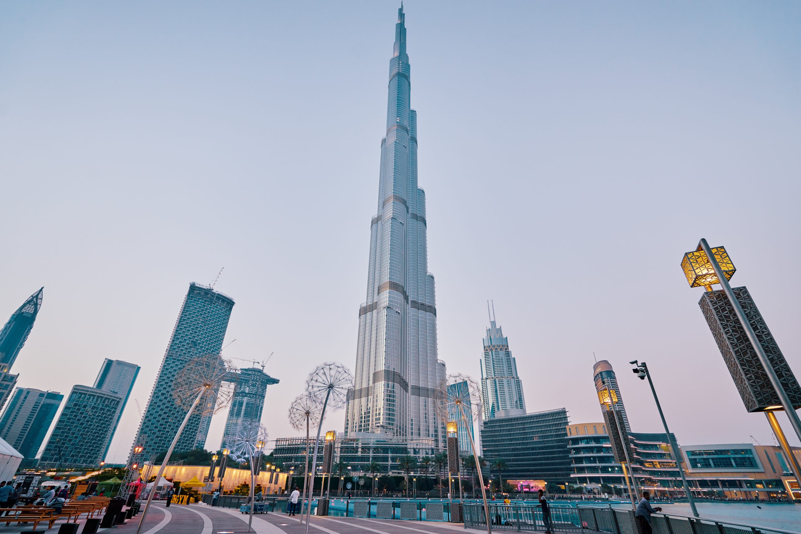 Big city lights. Cityscape of Dubai Downtown promenade with skyscrapers and fountains. The 8th of March 2018.
